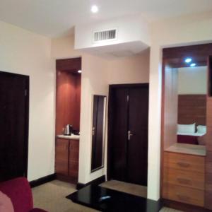 a hotel room with a bathroom with a mirror at BON Hotel Grand Towers in Abuja