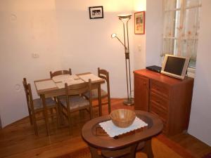 a dining room with a table and a laptop on a desk at Apartment 11 in Rovinj