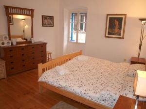 a bedroom with a bed and a dresser and a mirror at Apartment 11 in Rovinj