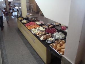 a buffet line with many different types of food at Goias Hotel in Goiânia