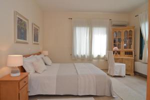 A bed or beds in a room at West Crete Chania - Villa Europa