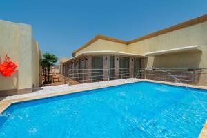a swimming pool in front of a house at Boudl Quraish in Jeddah
