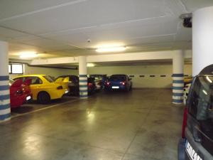 a row of parked cars in a garage at Hotel Cristina in Chianciano Terme