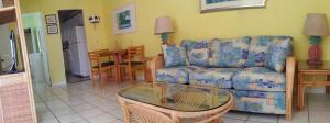 a living room with a couch and a table at Atlantic Sands Beach Suites in Hollywood