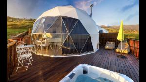 a gazebo on the deck of a house at Soul Glamping in Estreito da Calheta