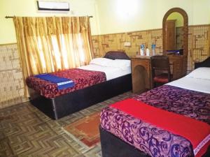 Ένα ή περισσότερα κρεβάτια σε δωμάτιο στο Rainbow Safari Resort