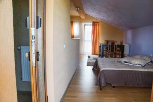 a bedroom with a bed and a dining room at Pensiunea Nicol in Valea Iasului