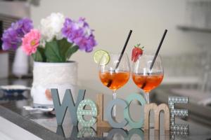 two glasses of wine on a table with a vow sign at Hotel Tosi in Riccione