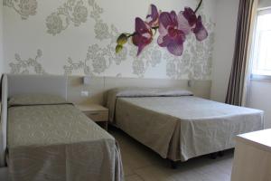 Postel nebo postele na pokoji v ubytování Hotel Alex