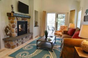 a living room with a fireplace and a couch at Newagen Seaside Inn in Southport