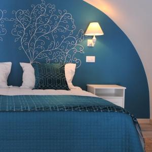 een slaapkamer met een bed met een muurschildering van bomen aan de muur bij Casa tra Borgo e Mare in Monopoli
