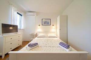 Postel nebo postele na pokoji v ubytování Apartments Rose