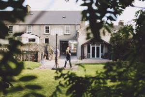 a group of people walking in front of a house at Hillside Lodge in Rostrevor