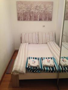 a bed with two towels on it in a room at Apartman Allegria in Zagreb