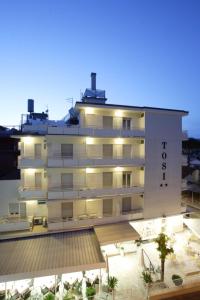 a large white building with a hotel at Hotel Tosi in Riccione