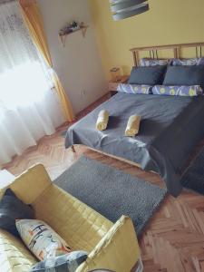 
a bed with a blanket and pillows on top of it at House Dado in Jezerce
