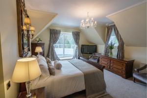 a bedroom with a large bed and a window at Tullyglass House Hotel in Ballymena +102 photos