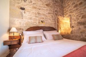 מיטה או מיטות בחדר ב-Torre Don Virgilio Country Hotel
