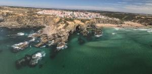 an aerial view of a rocky coastline with the ocean at Casa Sto. António in Zambujeira do Mar
