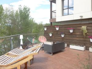 a deck with two chairs and a table on a balcony at Hotel Sanchez in Aínsa