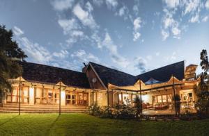 a large building with a grass yard in front of it at Villiera Guesthouse in Douglas