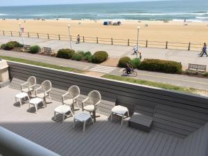 a balcony with chairs and a view of the beach at Ocean's 24 in Virginia Beach