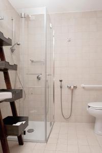 a bathroom with a shower and a toilet at Hotel Aquadulci in Chia