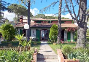 a house with a pathway in front of it at I Pini House in Magione