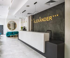 a lobby of alderman with a reception counter and chairs at Hotel Alexander in Krakow