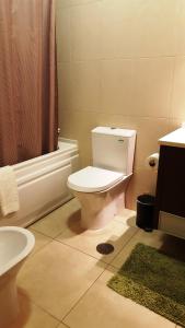a bathroom with a toilet and a sink and a shower at Plaza 305 Albufeira in Albufeira