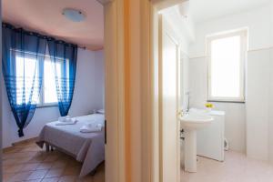 A bed or beds in a room at Furore Coast Rooms
