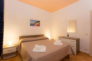 A bed or beds in a room at Furore Coast Rooms