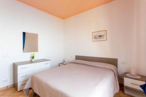 A bed or beds in a room at Furore Coast Rooms