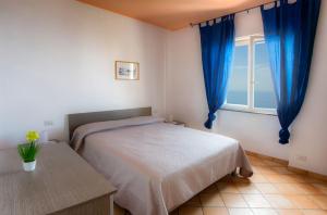 A bed or beds in a room at Furore Coast Rooms
