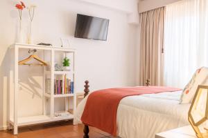 a bedroom with a bed and a book shelf at The Sea Beach House in Cortegaça