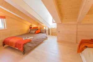 a large room with a bed in a attic at B&B White Moon in Gressoney-la-Trinité