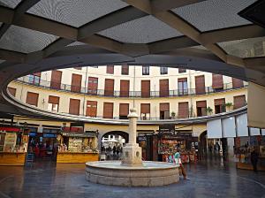 a building with a fountain in the middle of a mall at Puerto Bello in Valencia