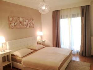 a bedroom with a white bed and a large window at B&B Marijana in Malinska