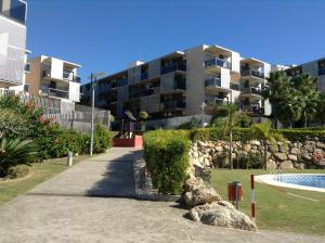 a apartment complex with a swimming pool and a building at Paradise Village in Salou