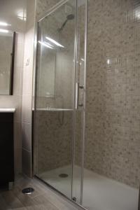 a shower with a glass door in a bathroom at Estrela do Mar in Albufeira