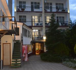 an apartment building with a staircase in front of it at Private Residence Osobnyak in Odesa