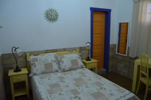Ένα ή περισσότερα κρεβάτια σε δωμάτιο στο Pousada Venerando