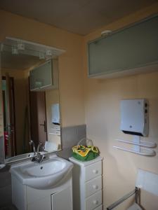 a bathroom with a sink and a mirror at P'tite Case in Mornas