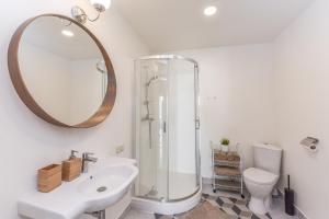 a bathroom with a shower and a sink and a mirror at Atsipūskit in Palanga +145 photos