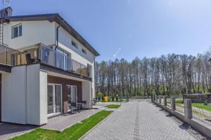 a building with a walkway in front of it at Atsipūskit in Palanga