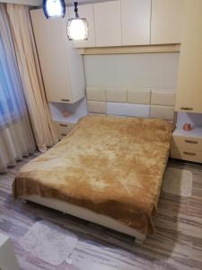 a bedroom with a large bed in a room at Tomis Apartament in Constanţa