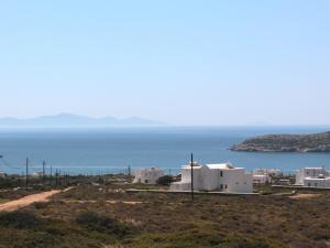 a view of white buildings and the ocean at Bonatsa House in Agios Georgios