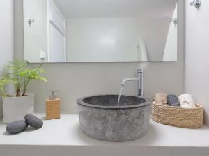 a bathroom with a stone sink with a faucet at Bonatsa House in Agios Georgios