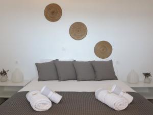 a bedroom with a bed with towels on it at Bonatsa House in Agios Georgios
