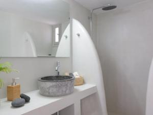 a bathroom with a sink and a mirror at Bonatsa House in Agios Georgios